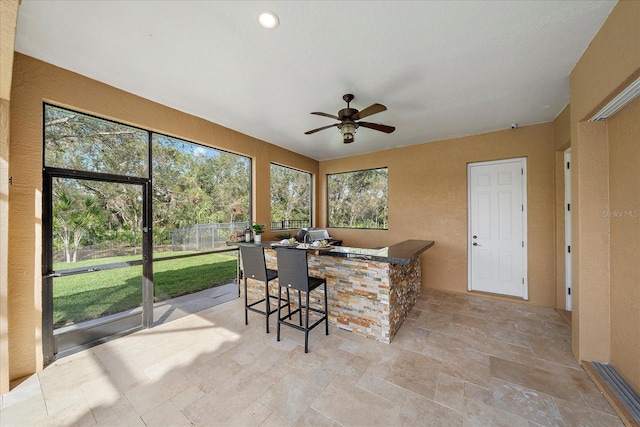 sunroom with ceiling fan