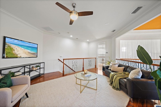 living room with ceiling fan, dark hardwood / wood-style flooring, and ornamental molding