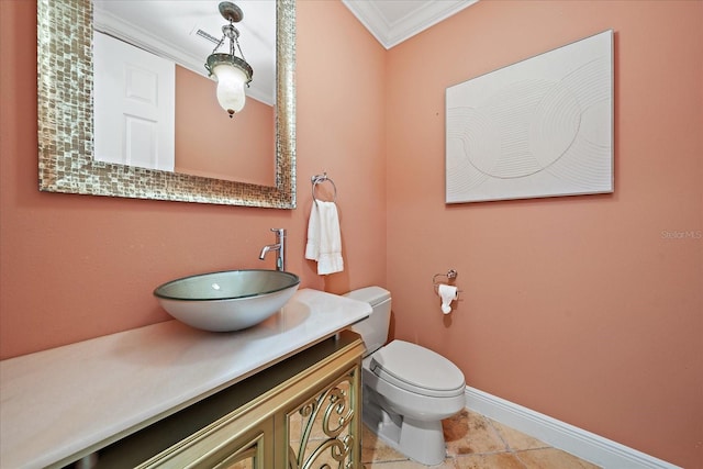 bathroom featuring tile patterned flooring, vanity, toilet, and ornamental molding