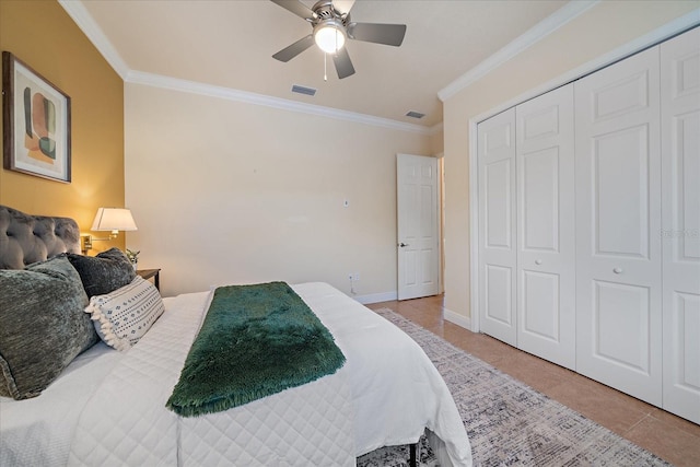 tiled bedroom featuring ceiling fan, a closet, and ornamental molding