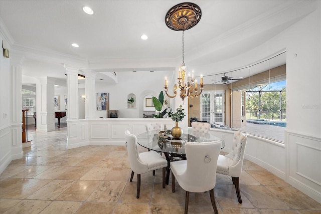 dining room featuring decorative columns, crown molding, and ceiling fan with notable chandelier