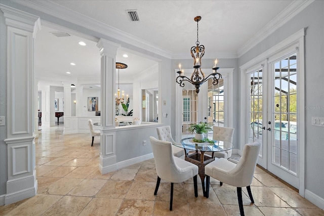 dining room with a chandelier, french doors, ornate columns, and crown molding