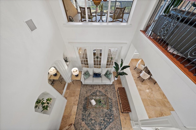 foyer featuring plenty of natural light and a towering ceiling