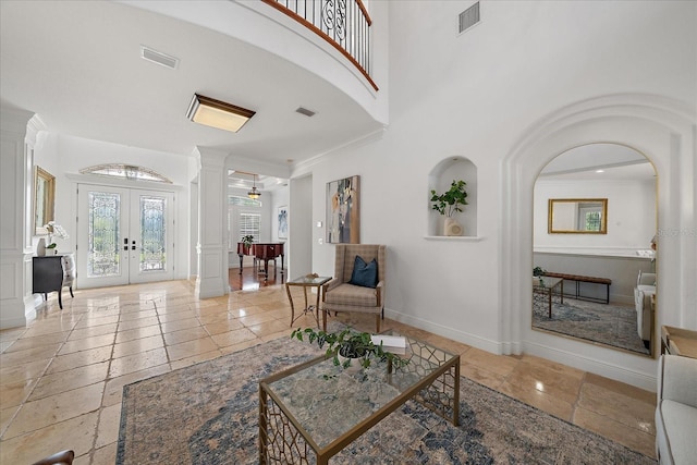 living room featuring french doors and ornamental molding