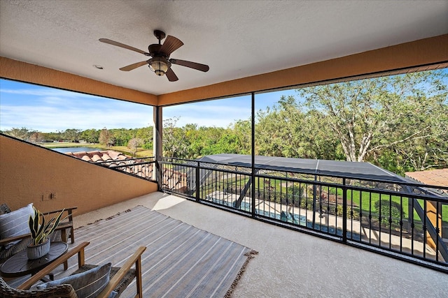 exterior space featuring ceiling fan and a balcony