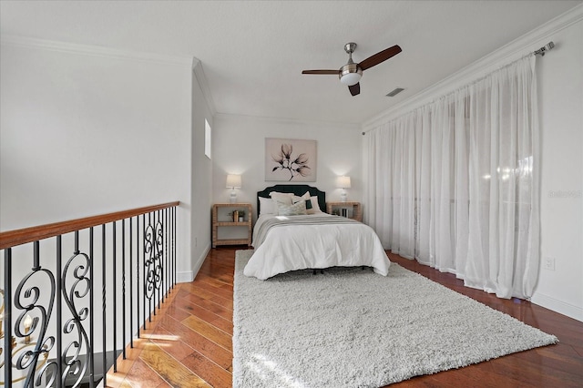 bedroom featuring hardwood / wood-style floors, ceiling fan, and ornamental molding