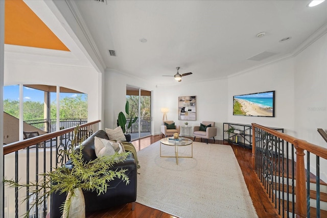 living room with ceiling fan, dark hardwood / wood-style flooring, and crown molding