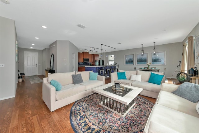 living room featuring hardwood / wood-style floors and rail lighting