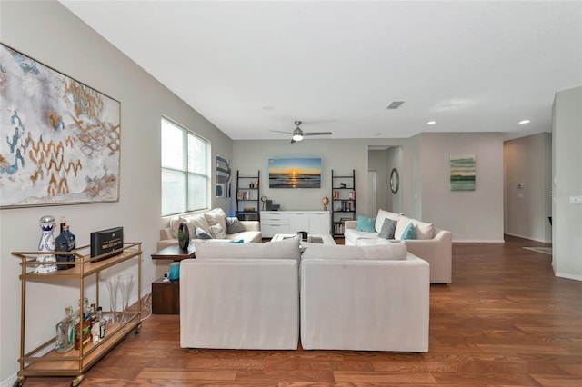 living room featuring ceiling fan and hardwood / wood-style floors