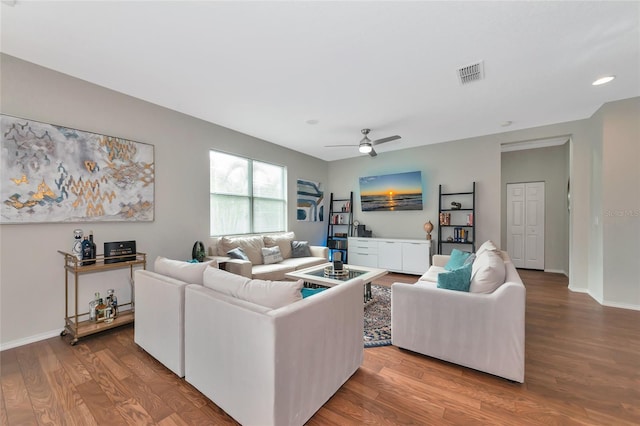 living room featuring ceiling fan and hardwood / wood-style floors