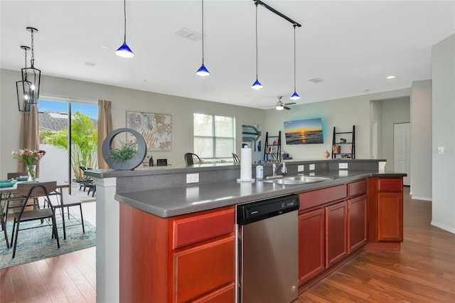 kitchen featuring stainless steel dishwasher, a center island with sink, dark hardwood / wood-style flooring, ceiling fan, and sink