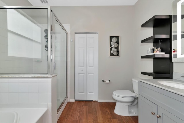 full bathroom with toilet, vanity, hardwood / wood-style flooring, and plus walk in shower