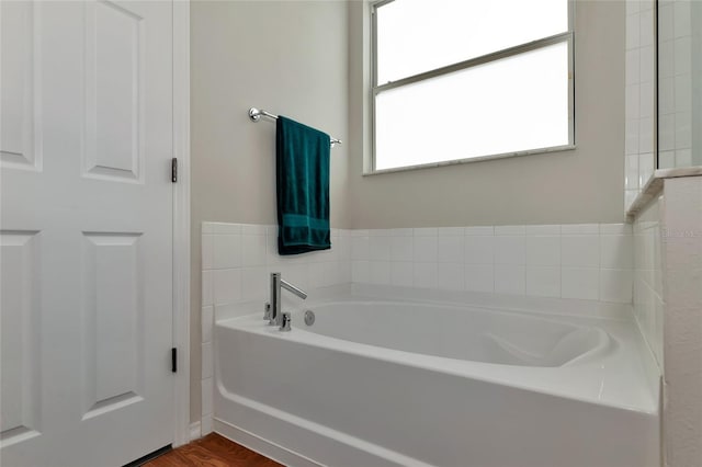 bathroom featuring hardwood / wood-style flooring and a bathing tub