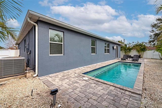 view of pool with a patio area and central air condition unit