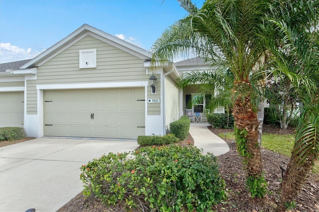 single story home with covered porch and a garage