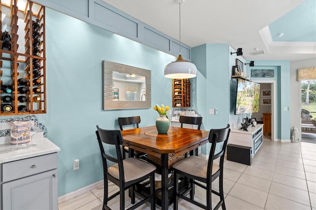 dining space with light tile patterned floors and a textured ceiling