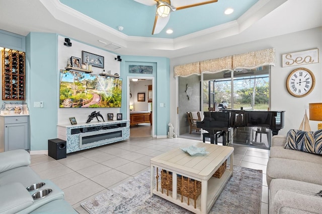 3922 Wildgrass Pl, Parrish, FL 34219 - living area with a tray ceiling, crown molding, ceiling fan, light tile patterned floors, and baseboards