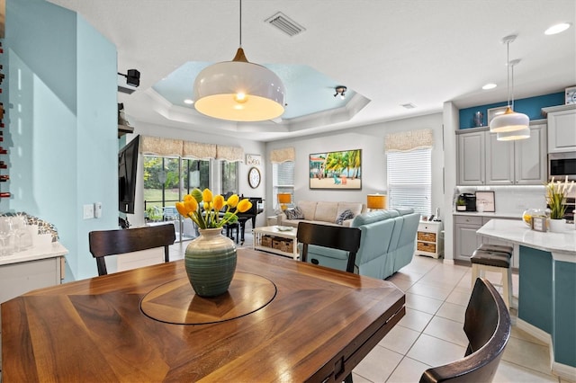 3922 Wildgrass Pl, Parrish, FL 34219 - dining space with healthy amount of natural light, light tile patterned floors, recessed lighting, and a tray ceiling