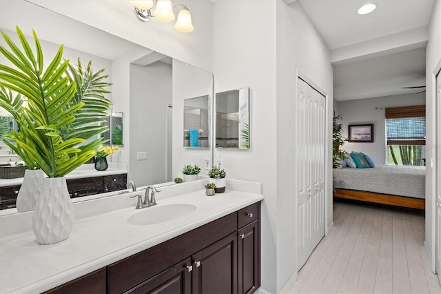 3922 Wildgrass Pl, Parrish, FL 34219 - full bath featuring ensuite bath, vanity, wood finished floors, and recessed lighting