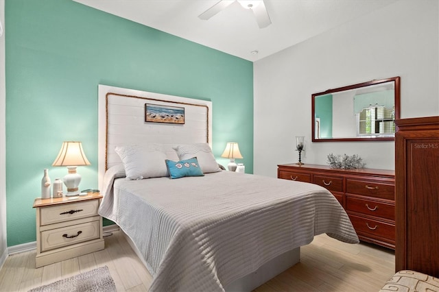 3922 Wildgrass Pl, Parrish, FL 34219 - bedroom with light wood finished floors, a ceiling fan, and baseboards