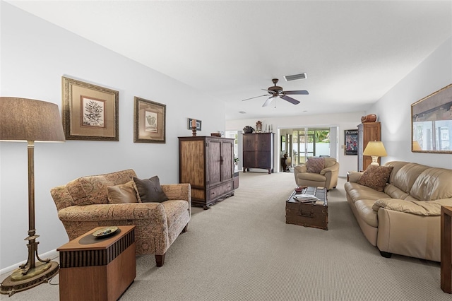 carpeted living room featuring ceiling fan