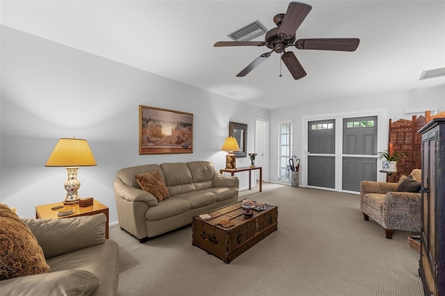 carpeted living room with ceiling fan