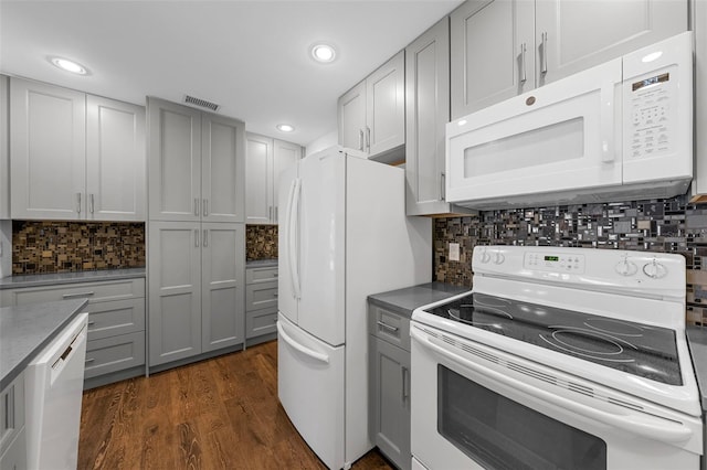 kitchen featuring gray cabinetry, decorative backsplash, and white appliances