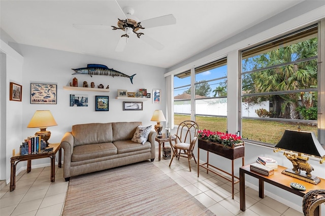 living room featuring ceiling fan, plenty of natural light, and light tile patterned flooring