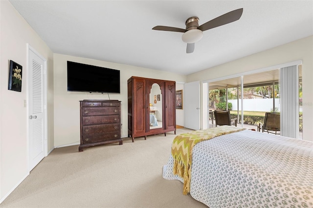 carpeted bedroom with ceiling fan and access to outside