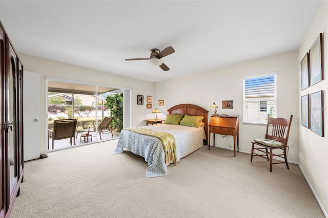 carpeted bedroom with access to outside and ceiling fan