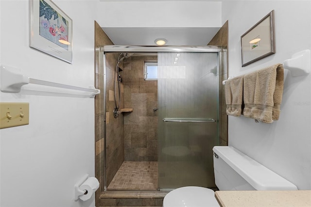 bathroom featuring an enclosed shower and toilet