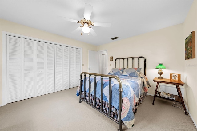 carpeted bedroom with a closet and ceiling fan