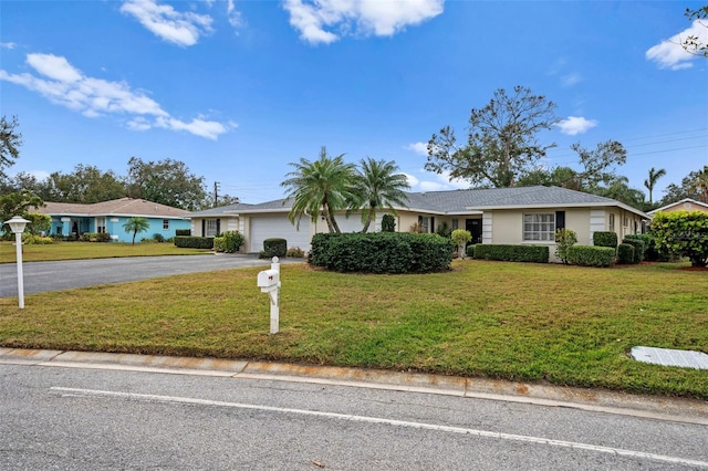 ranch-style home with a front yard and a garage