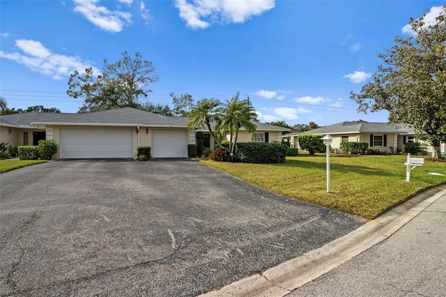 single story home with a front yard and a garage