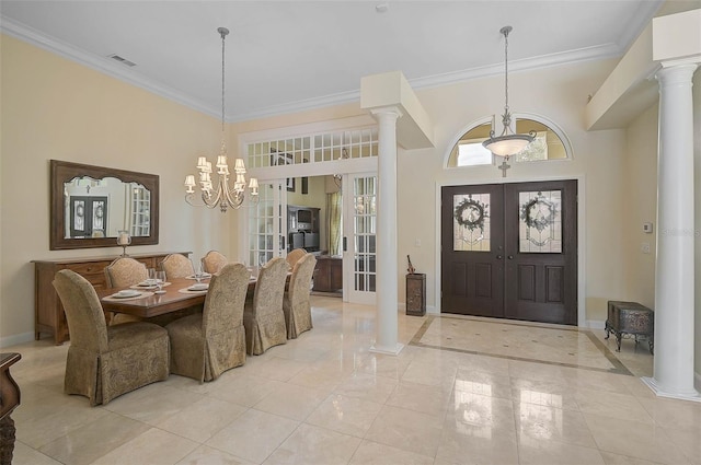 entrance foyer with ornate columns, crown molding, french doors, and an inviting chandelier