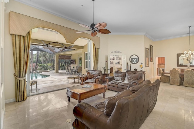 tiled living room with ornamental molding and ceiling fan with notable chandelier