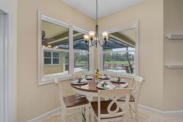 tiled dining space featuring a chandelier