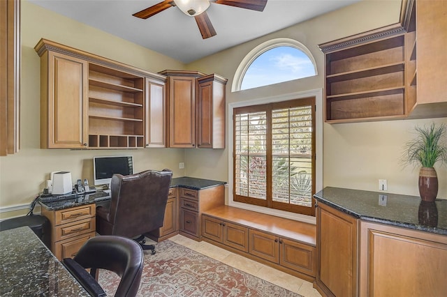 office featuring built in desk, light tile patterned floors, and ceiling fan