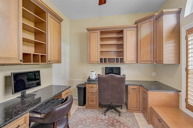 office area with light tile patterned floors and built in desk