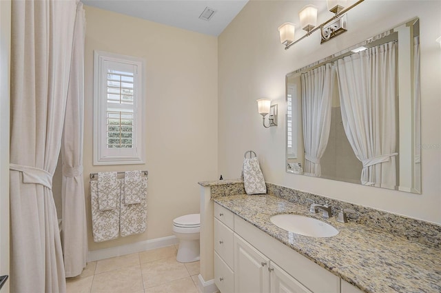 bathroom featuring toilet, tile patterned floors, and vanity