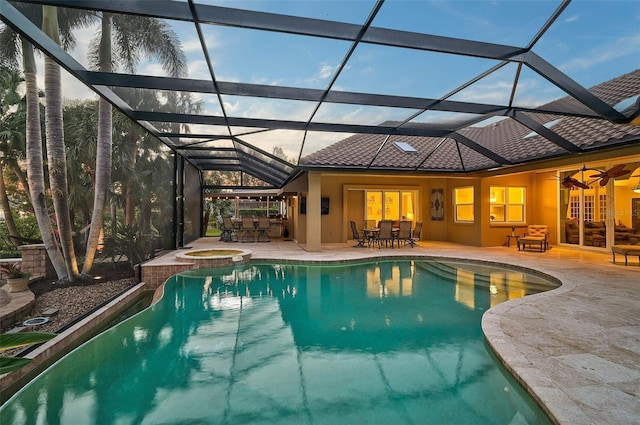 view of pool with a lanai, ceiling fan, a patio area, and an in ground hot tub