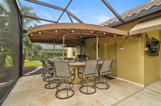 view of patio with area for grilling, exterior kitchen, and an outdoor bar