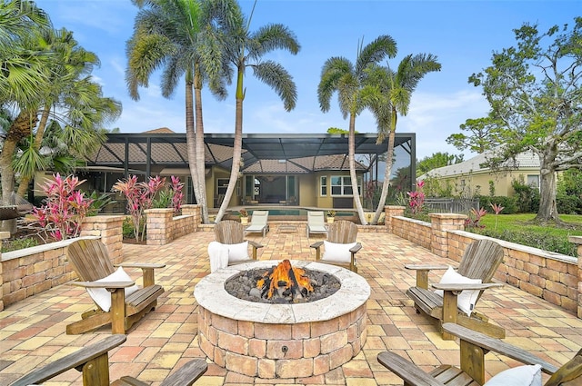 view of patio / terrace featuring a lanai and an outdoor fire pit