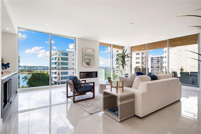 tiled living room with expansive windows and a healthy amount of sunlight