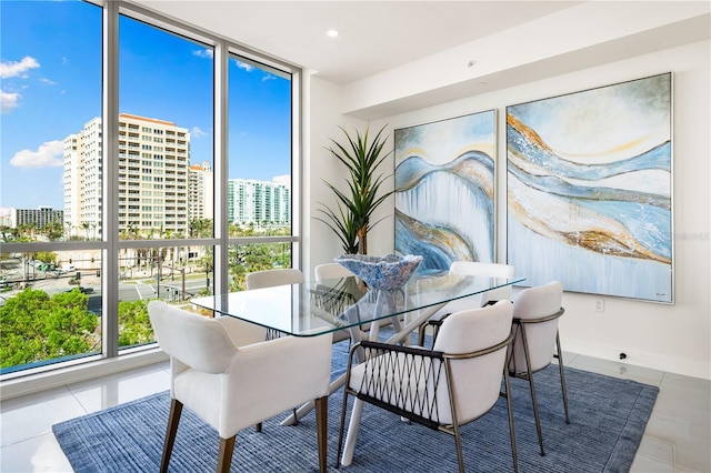 dining room with tile patterned flooring, a wealth of natural light, and floor to ceiling windows