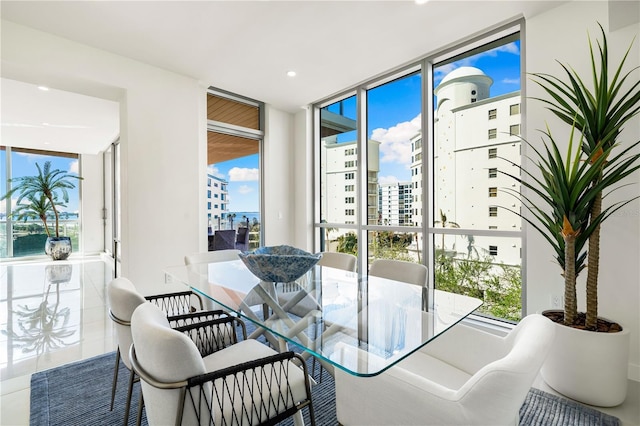 tiled dining area with floor to ceiling windows