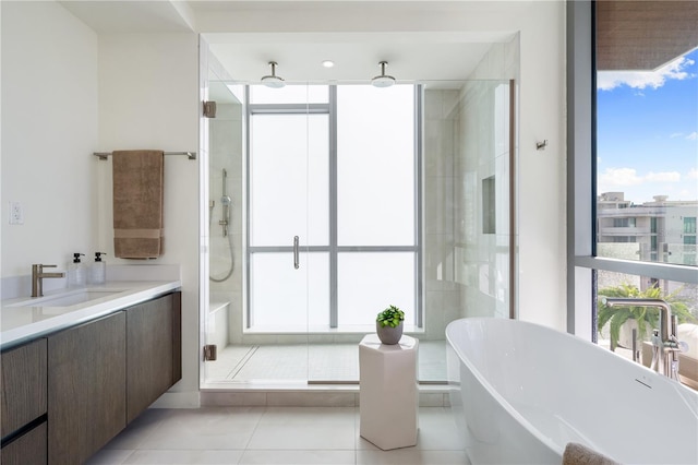 bathroom featuring shower with separate bathtub, floor to ceiling windows, and a healthy amount of sunlight