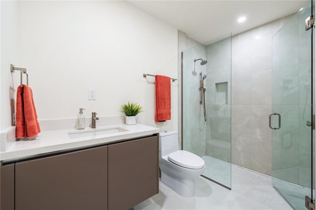 bathroom featuring walk in shower, vanity, tile patterned floors, and toilet