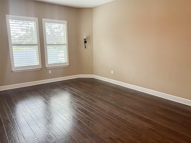 empty room featuring dark wood-type flooring