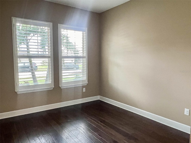 empty room with dark hardwood / wood-style floors